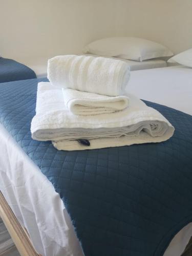 a stack of towels sitting on top of a bed at B&B Crispino in Belvedere Marittimo