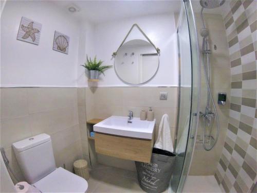 a bathroom with a toilet and a sink and a shower at Aloha G.C. in Las Palmas de Gran Canaria