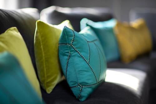 a group of pillows sitting on a couch at Hotel Plaza e de Russie - Relais & Châteaux in Viareggio