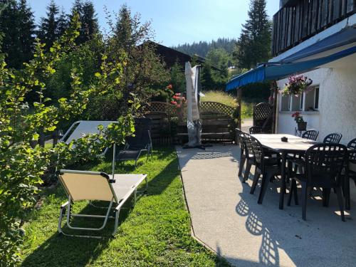 a patio with tables and chairs and a fountain at Route des Joncs 300 Appartemen in Les Paccots
