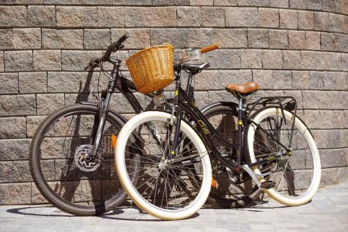 two bikes are parked next to a brick wall at Penzion Lesni in Milovice