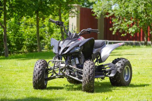 a four wheeler parked on the grass in a field at Penzion Lesni in Milovice