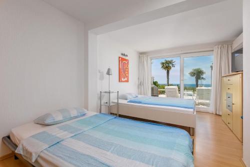 a bedroom with two beds and a view of the ocean at Villa Lina in Vrsar