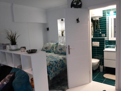 a bathroom with a bed and a toilet and a sink at Apartments Paris in Umag