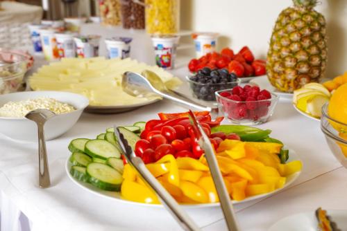 a table topped with plates of fruits and vegetables at Penzion Lesni in Milovice