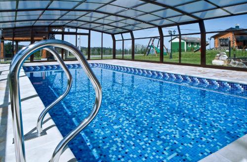 a swimming pool with blue tiles on the side of it at Apartamentos Rurales El Fresnu in Silvamayor