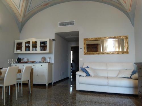 a living room with a white couch and a table at oltremare soul houses in Chiavari