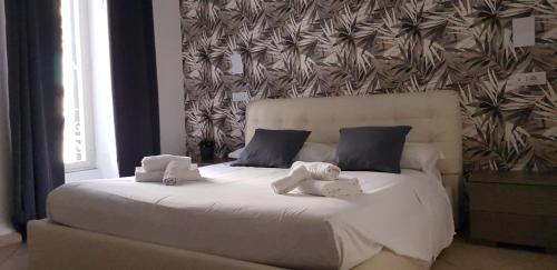 ローマにあるCampo de Fiori Houseのベッドルーム1室(白いベッド1台、タオル2枚付)
