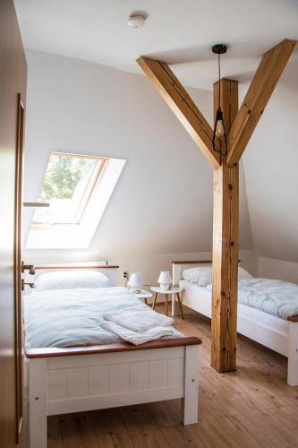 a bedroom with two beds and a skylight at Penzion-apartmán Souček in Jindrichuv Hradec