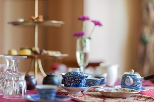 a table with blue and white cups and plates on it at Beaconsfield Bed and Breakfast - Victoria in Victoria