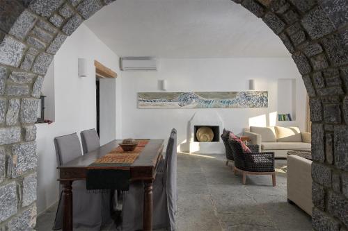 a living room with a table and a fireplace at Aquavisionaire Beach Front Villa in Líndos
