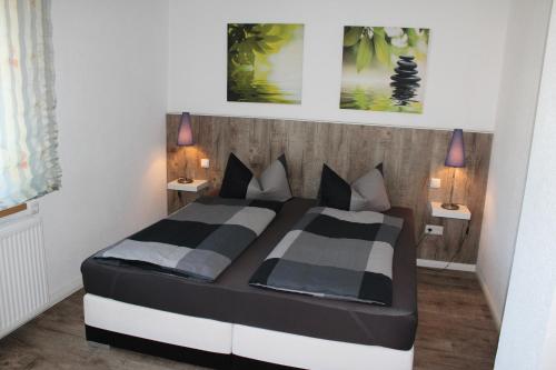 ein Schlafzimmer mit einem schwarzen und weißen Bett und zwei Lampen in der Unterkunft Spreewald Unterkünfte in Briesensee