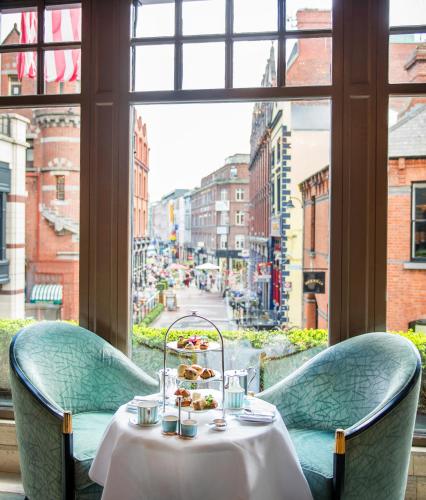 a table in a restaurant with a view of a street at The Westbury Hotel in Dublin