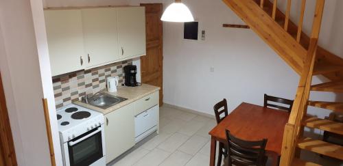 a kitchen with a sink and a stove and a table at Olive Press Hotel in Mithymna