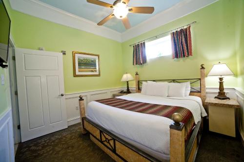 a bedroom with a bed and a ceiling fan at DeSoto Beach Gardens in Tybee Island