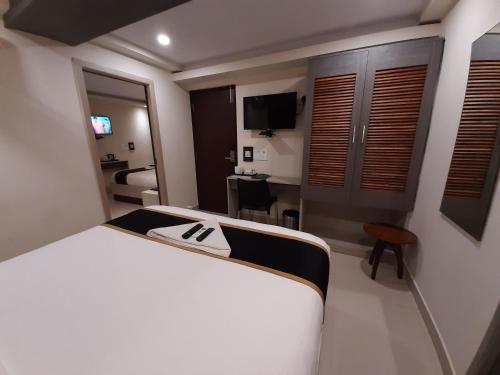 a hotel room with a bed and a desk at Liza Regency in Chennai