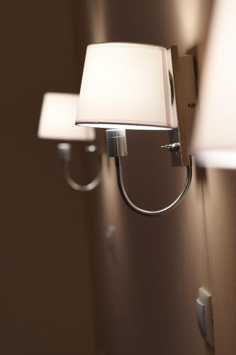 a light attached to a wall with two lights at Hotel Solon in Tolo