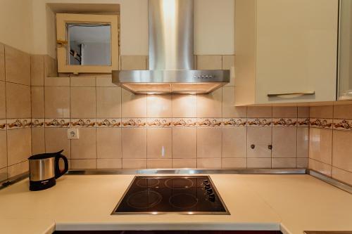 a kitchen with a stove top oven in a kitchen at Apartmani Jasna in Herceg-Novi