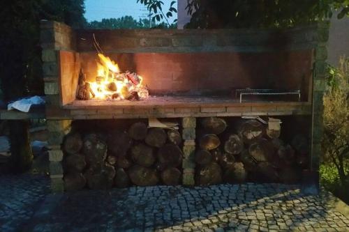a brick fireplace with a fire in it at piccolo casale a "le Moline" in una vera fattoria in Vetralla