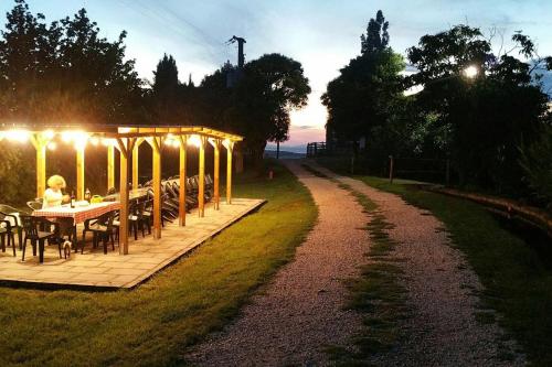 a table and chairs on a patio with lights at piccolo casale a "le Moline" in una vera fattoria in Vetralla