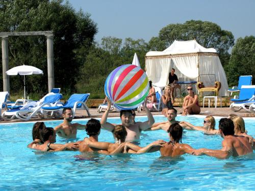 a group of people in a swimming pool with a beach ball at Hotel Azzun Orient SPA&Wellness in Kromerowo