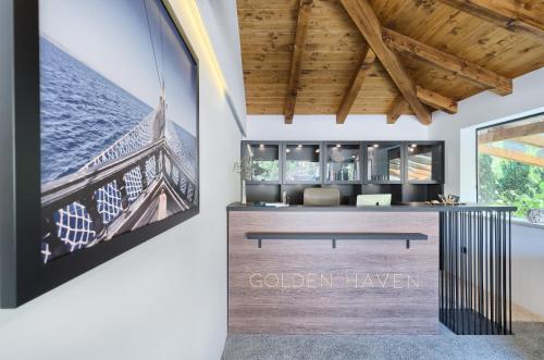 an office with a reception desk with a sign on the wall at Golden Haven Luxe Bungalow Resort in Murter