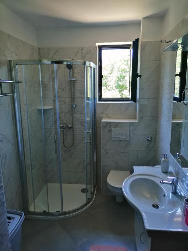 a bathroom with a shower and a toilet and a sink at ASTREA in Rijeka