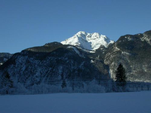 a snow covered mountain with a snow covered mountain at Ferienhaus Feuerer in Obertraun