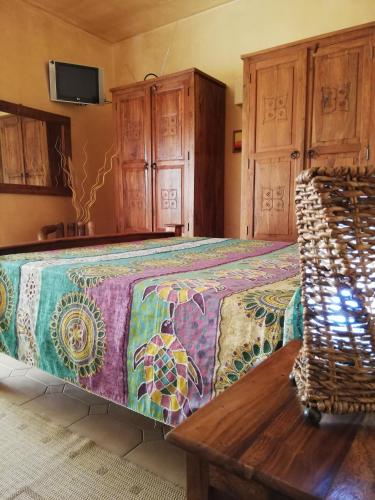 a bedroom with a large bed and wooden cabinets at Villa Santa Elena B&B - Country Home Holiday in Sala Consilina