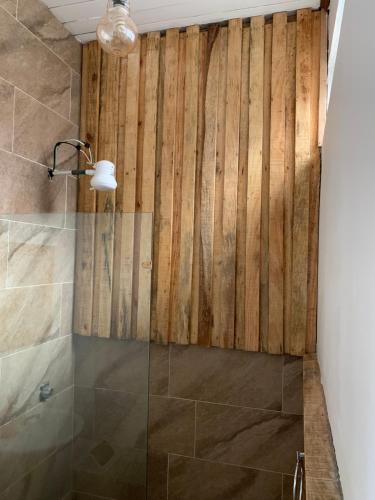 a bathroom with a shower with a glass door at Hotel Cortez Azul in Alajuela City