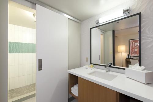 
a bathroom with a mirror and a sink at Plaza Hotel & Casino in Las Vegas
