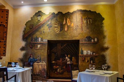 a room with a painting on the wall in a restaurant at Hotel Boutique Casona de la China Poblana - Adults Only in Puebla
