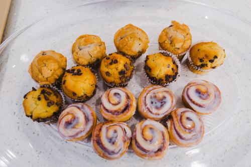 a plate of pastries and muffins on a table at Palace Inn- Louetta in Spring