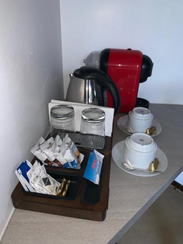 a table with a coffee pot and a tray of food at Villa Cuore in Tavernerio