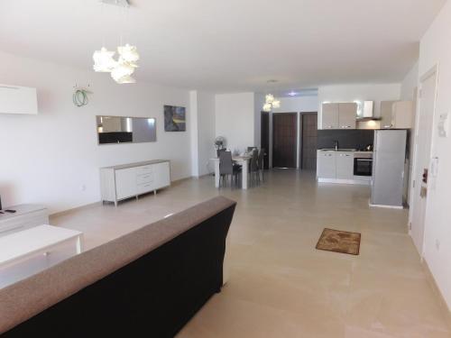 a large kitchen and living room with white walls at Paradise in Għajnsielem