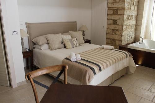 a bedroom with a bed and a tub and a sink at Il Trappeto in Vieste