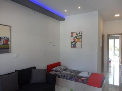 a living room with a couch and a blue ceiling at George apartments in Kallithea Halkidikis