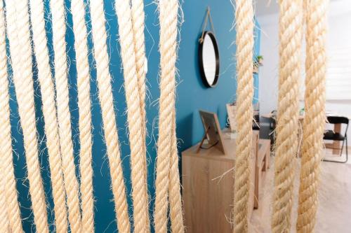 a room with blue walls and a wall with ropes at JOY'S HOME in Kalamata