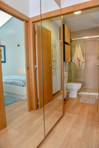 a bathroom with a glass shower and a toilet at Apartamento Mar II WITH PARKINg in Sesimbra