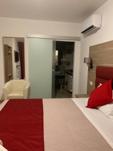 a bedroom with a large bed with a red blanket at Villa Cuore in Tavernerio