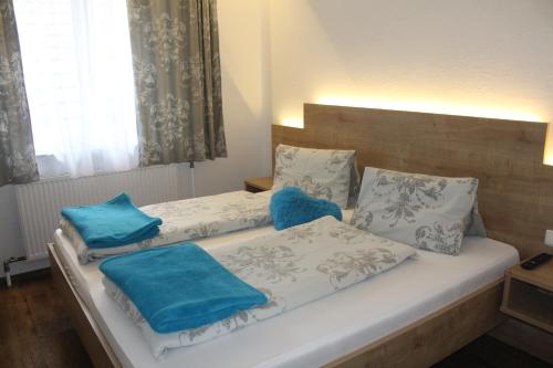 a bedroom with two beds with blue pillows at Arrahof in Harmannschlag