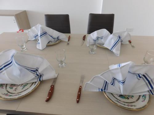 a table with plates and napkins on top of it at Paradise in Għajnsielem