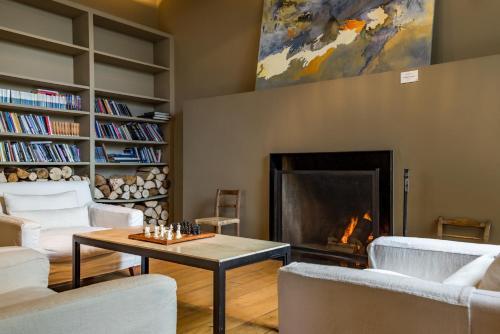 a living room filled with furniture and a fire place at Enjoy Puerto Varas in Puerto Varas