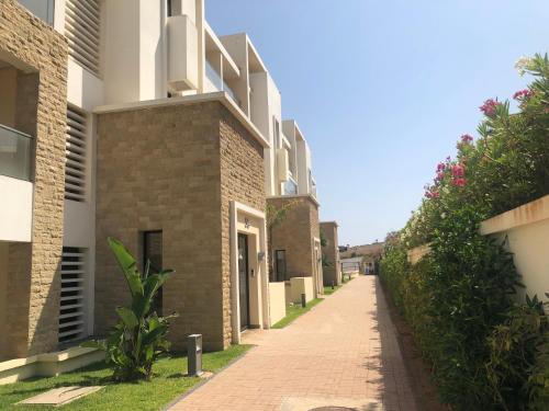 a brick alleyway between two buildings at Luxury Apartement Near the Beach in Sidi Bouqnadel