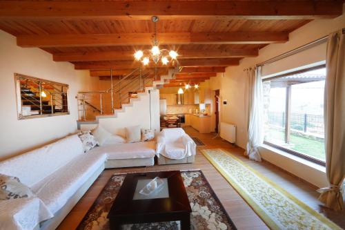 - un salon avec un grand canapé et un escalier dans l'établissement La Noi, à Sidhirokhórion