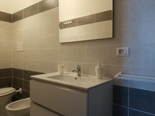 a bathroom with a sink and a toilet at B&B Via Nazionale in Milazzo