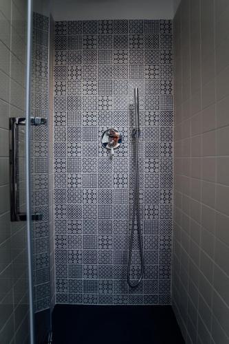 a shower in a bathroom with a tile wall at La Maison Golfo dei Poeti in Lerici