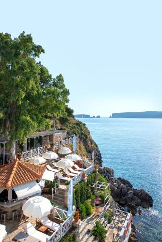 a resort with a bunch of umbrellas and the water at Karalis Beach in Pylos