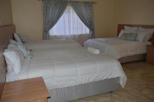 Postel nebo postele na pokoji v ubytování Chitova’s Guesthouse