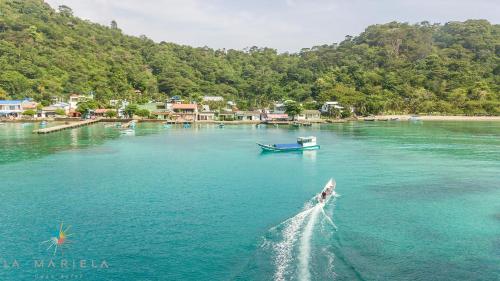 a boat is in the water on a river at Casa Hotel La Mariela in Sapzurro
